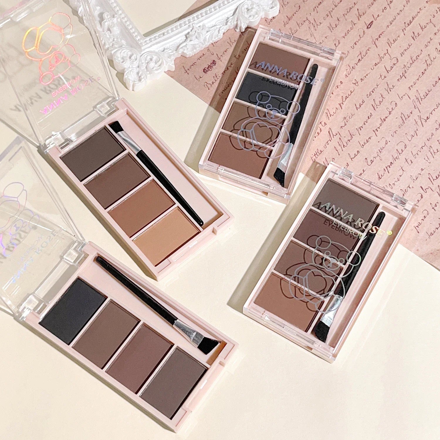 A set of 4-color eyebrow powder trays with brushes in gray and brown matte tones for long-lasting color rendering, filling and s